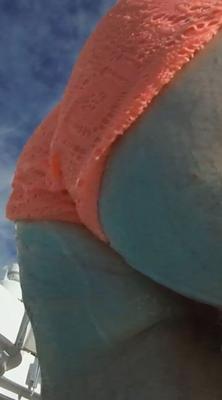 Getting out of the pool behind a MILF adjusting her bikini....