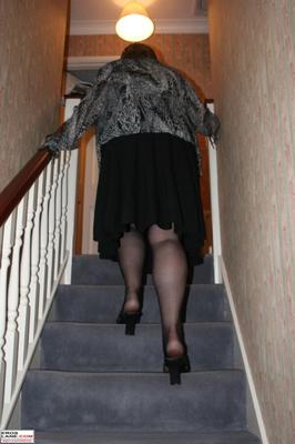 Chubby mature Claire posing at the top of her stairway.