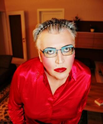 Mature Tranny in red satin blouse