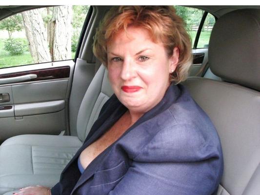 sexy mature removing her bra in the car