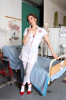 Mature nurse Kitty pleasures herself on a hospital bed.