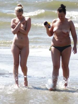 Mom and daughter walking on the beach